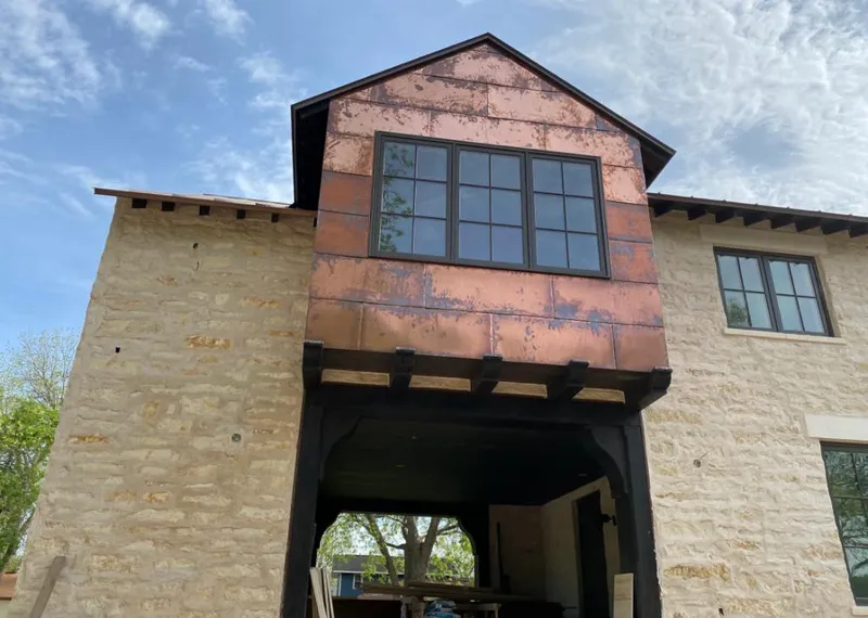Copper metal panel facade on a stone building for Metal Roof Coating in Farmville