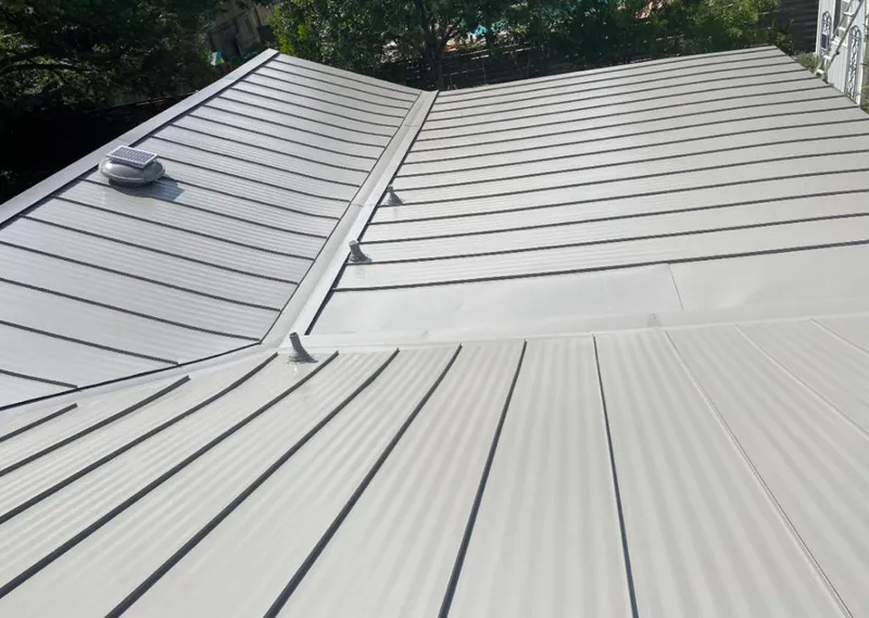 Solar attic fan installed on a metal roof for Roof Ventilation in Farmville
